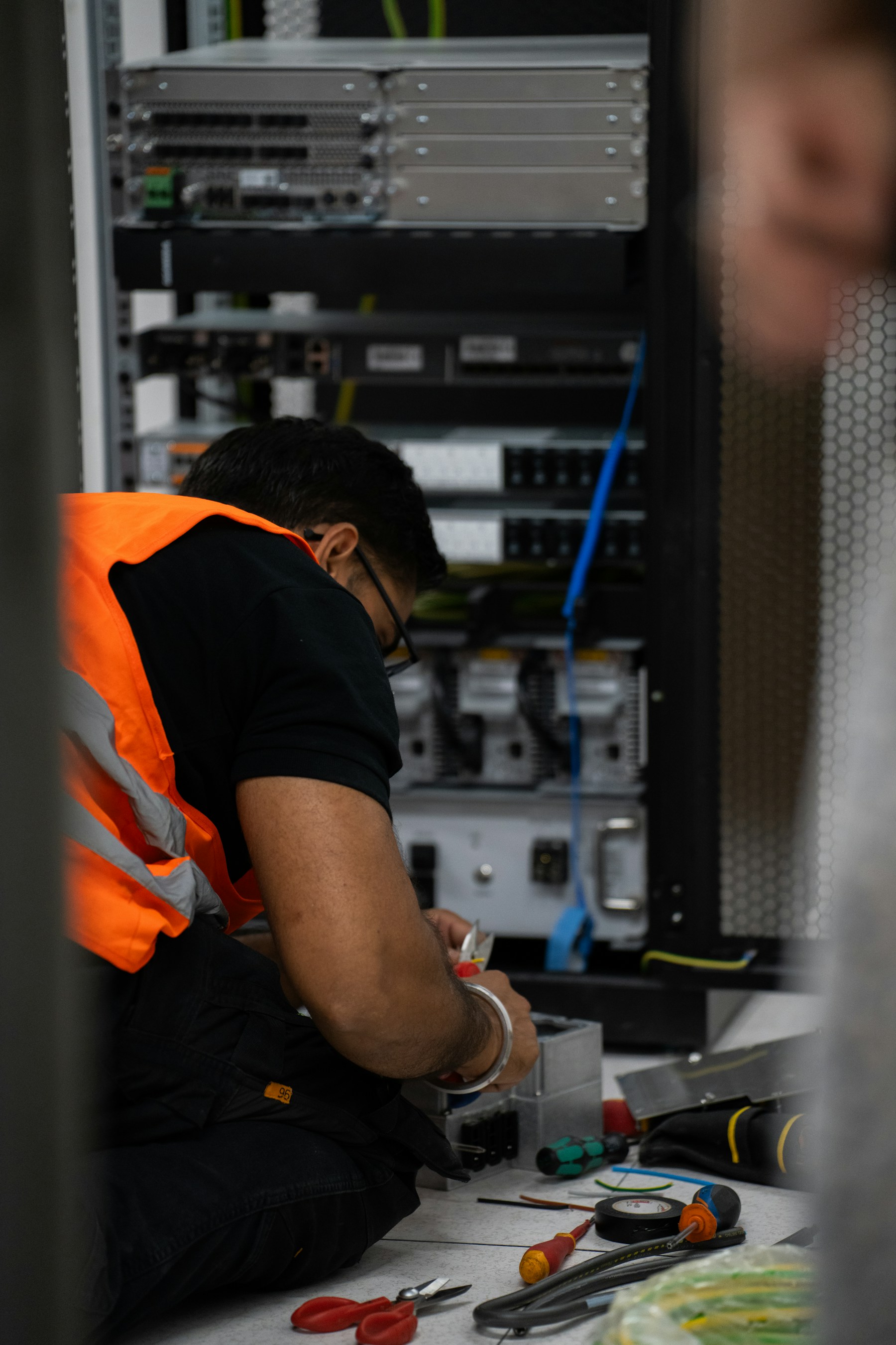 Technician working on server equipment with tools